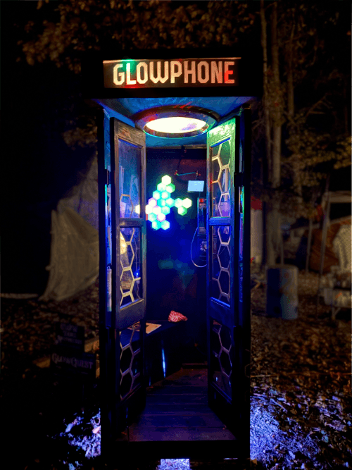 Payphone booth with glowing lights and sign titled GLOWPHONE